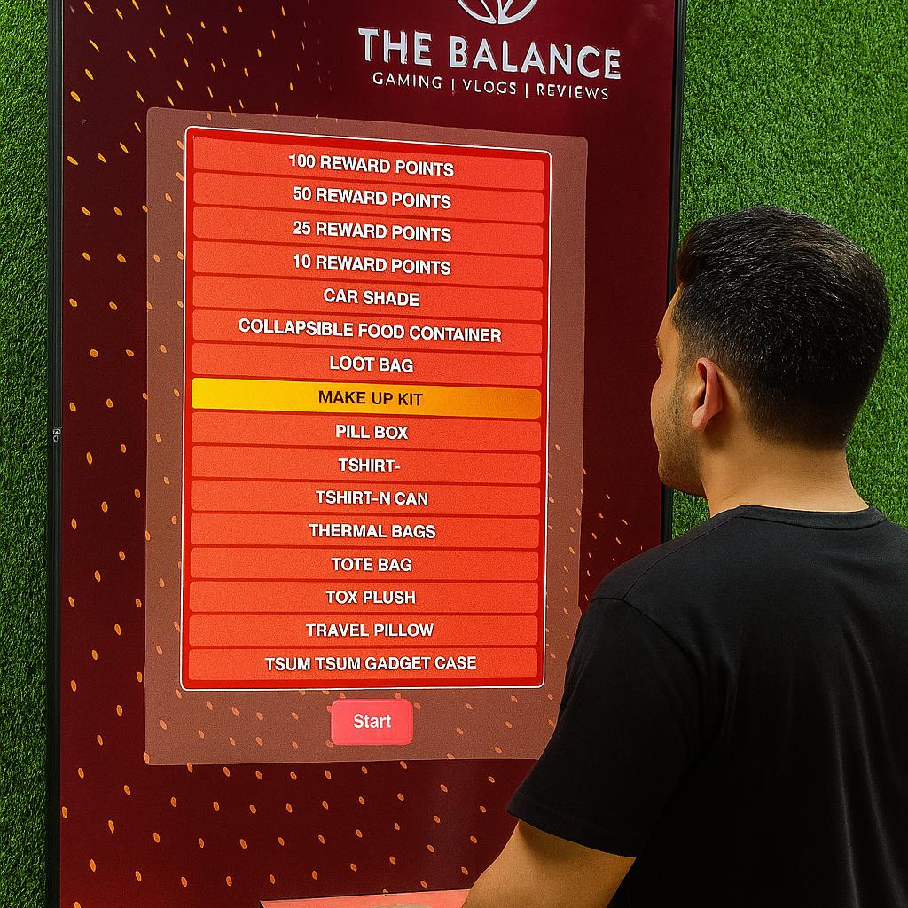 Guest playing interactive event game at exhibition booth in Dubai, pressing button to win prize, with branded screen display and selfie sharing feature for engagement.